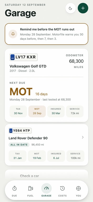 Two cars in the garage, each with its MOT date